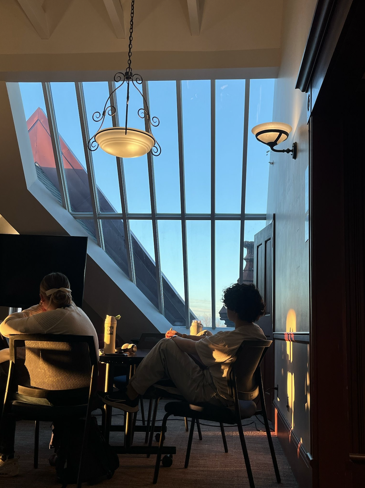Birdie Keller sits, largely obscured by shadows, in Old Main's fourth floor, and looks pensively out the skylight window.
